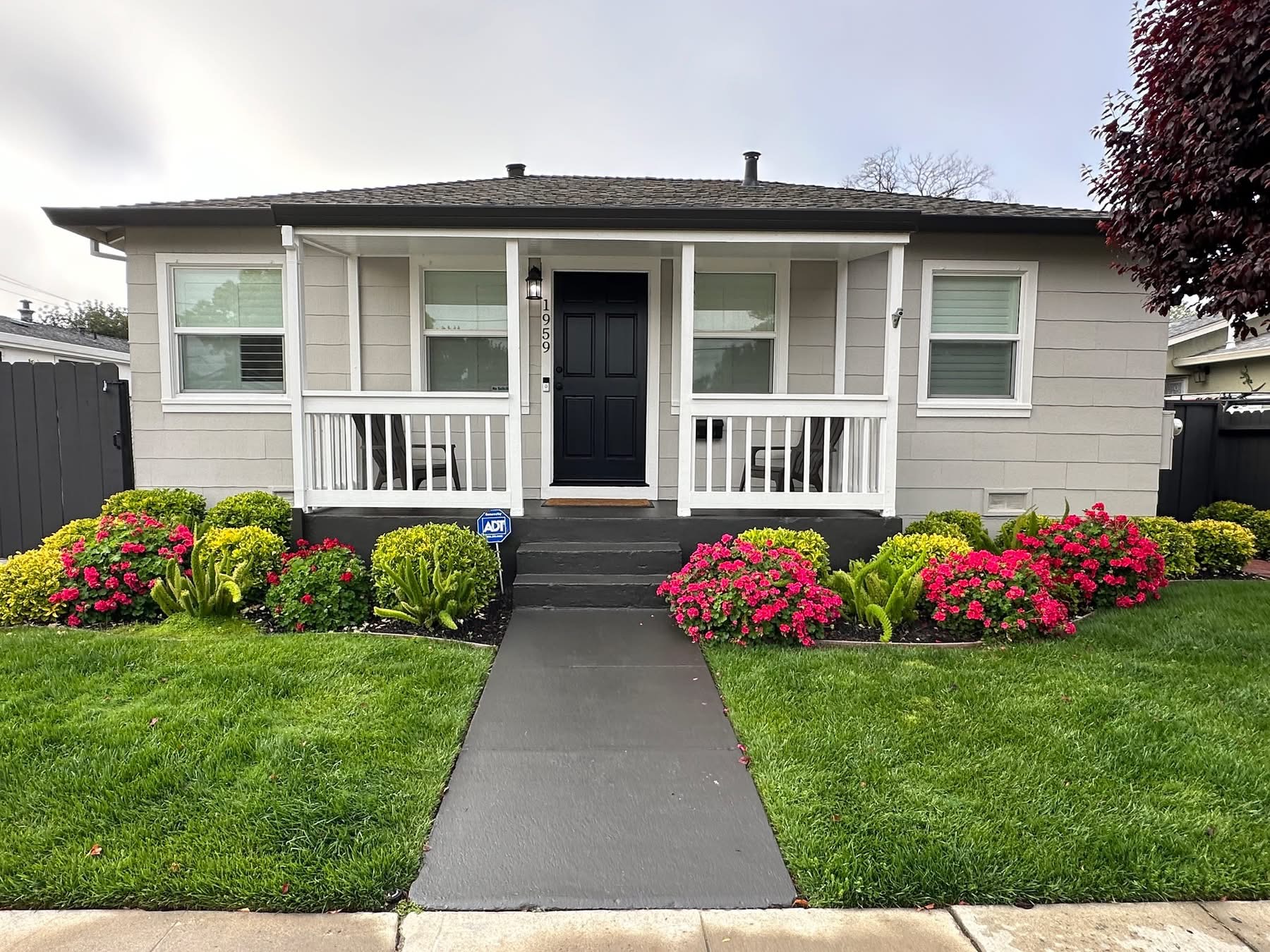 White craftsman home with covered porch and fresh exterior paint